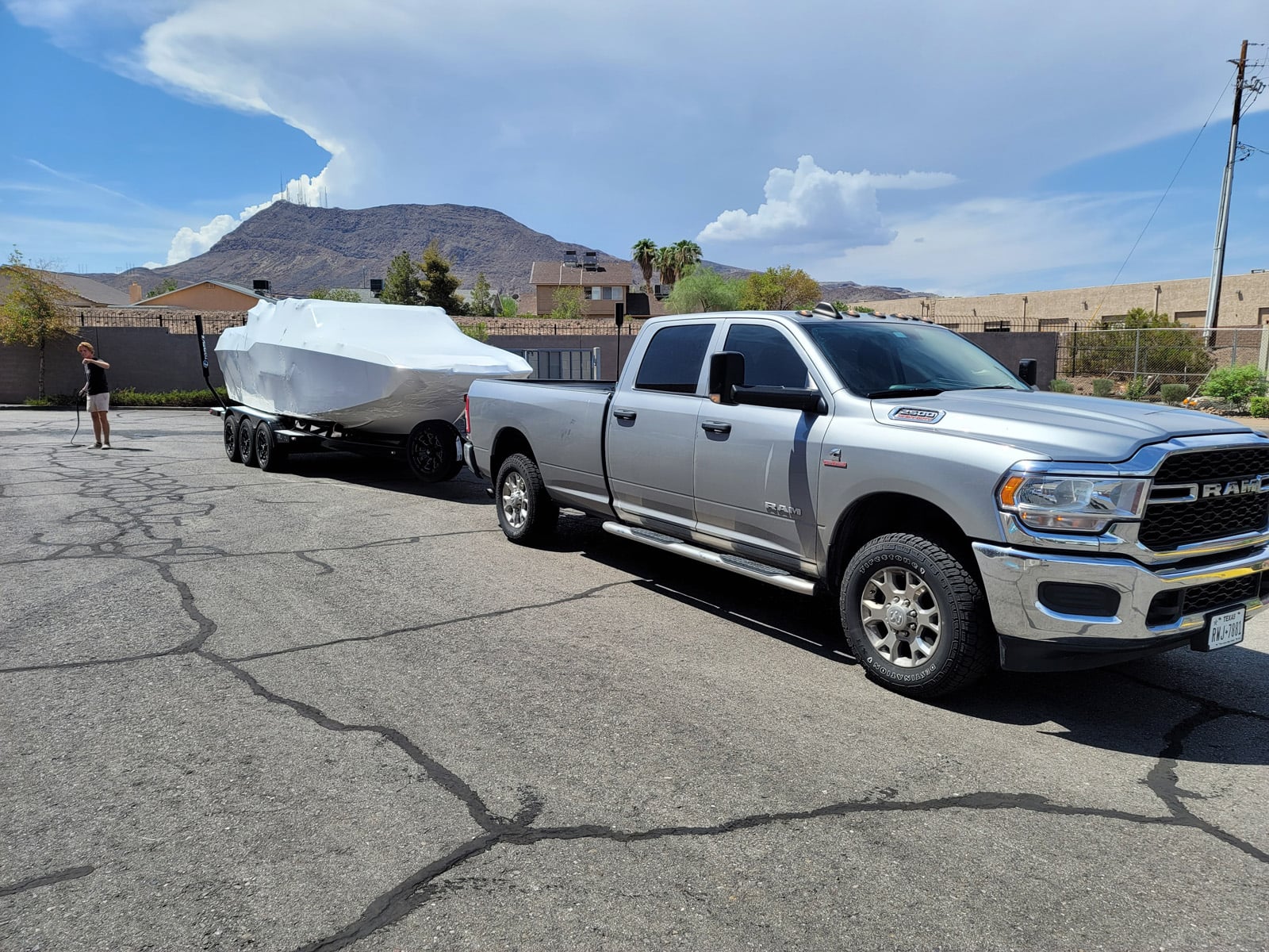 truck transporting shrink wrapped boat